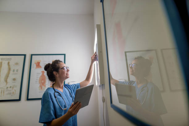 istock Doctor holding tablet and looking at x-ray. Technology in medicine concept. 1055997330
