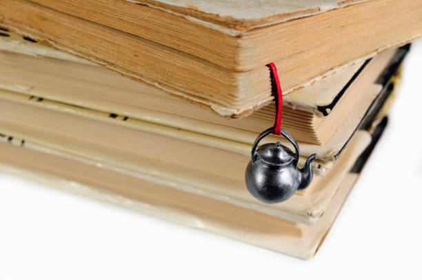 Stack of used books with a hand-made bookmark