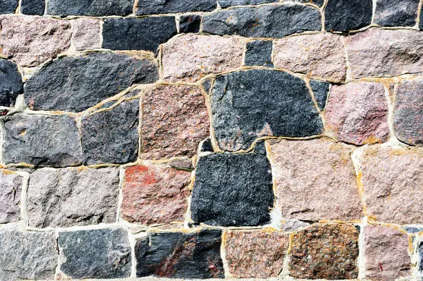 A rough wall made of cemented stones