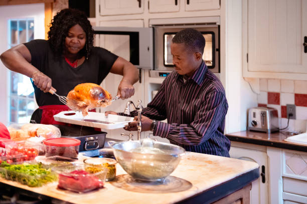 istock 1Thanksgiving dinner with American-African family preparing dinner 1056003390
