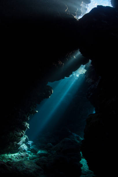 istock Dark, Underwater Cavern and Beams of Light 1056005812