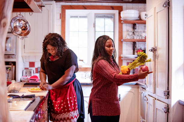 istock Thanksgiving dinner with American-African family preparing dinner 1056006282