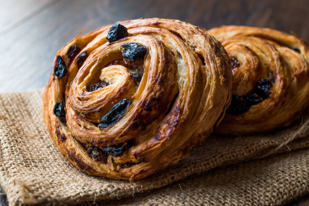 istock Danish Spiral Cinnamon Raisin Roll / German Pastry Schnecken on Sack. 1056012530