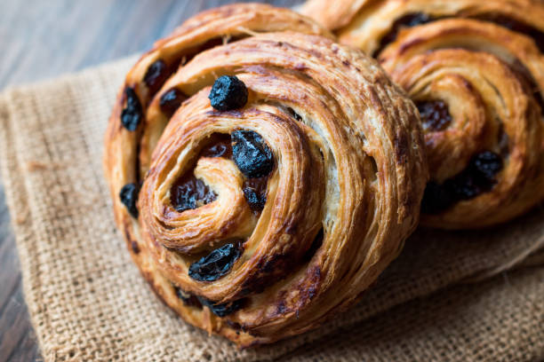 istock Danish Spiral Cinnamon Raisin Roll / German Pastry Schnecken on Sack. 1056013250