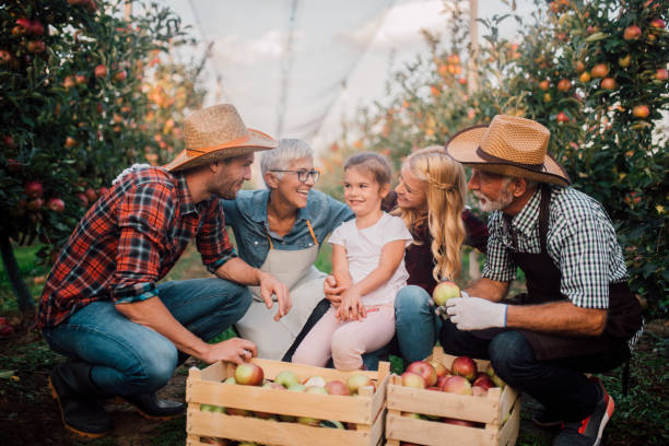 istock Happy family at apple filed 1056014842