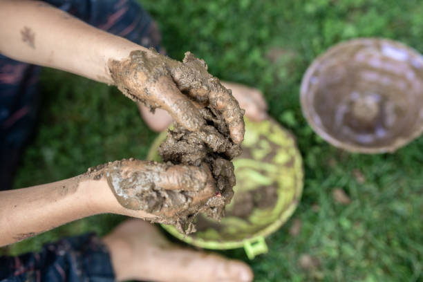 istock Toddler child playing with mud 1056014980