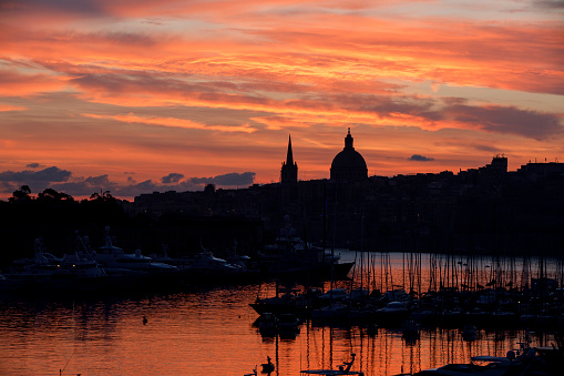 A shot at sunrise of the Valletta skyline with manoel island and the yacht marina in the foreground