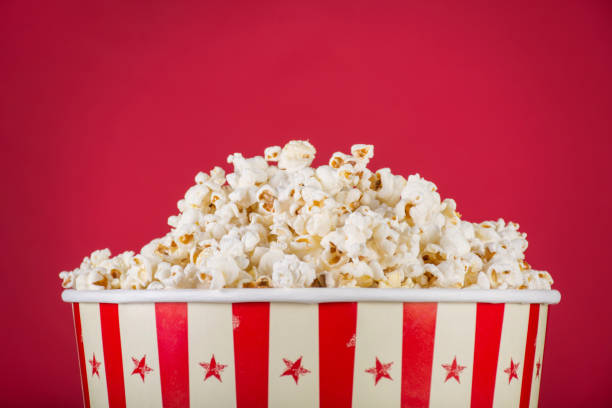 istock Popcorn in retro box isolated on red background 1056018654