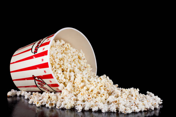 istock Retro red and white popcorn box spilled on black 1056018658