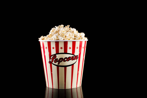 istock Retro popcorn box in red and white color and full with popcorn 1056018664