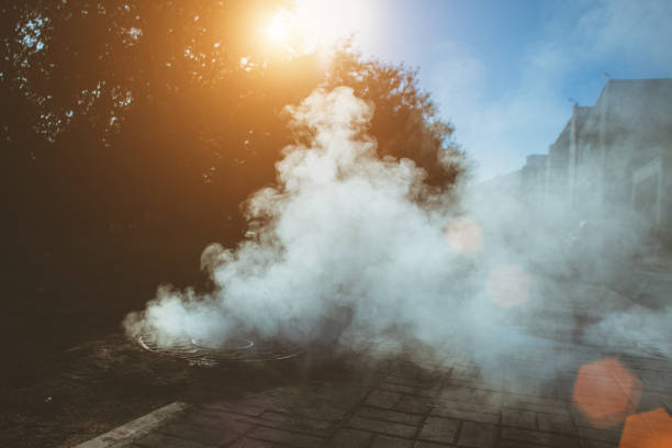 istock Accident on the heating line under the ground - thick steam from under the sewer manhole 1056019440