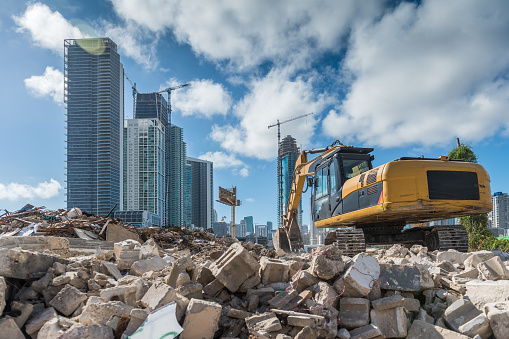 Heavy machinery cleaning a rubble site for a new housing development site in Miami.