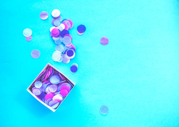 istock Multicolored confetti and sparkles on blue background. 1056022170