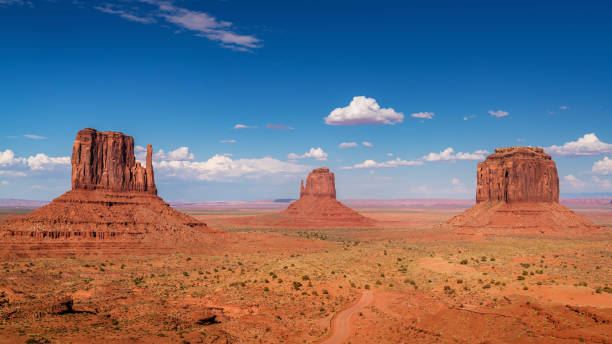 Panorama Monument Valley Arizona USA Panorama of scenic view towards the famous Mittens, the Monument Valley Rock Formations with West Mitten Butte and Merrick Butte under beautiful summer sky. Monument Valley, Arizona, USA. monument valley tribal park photos stock pictures, royalty-free photos & images