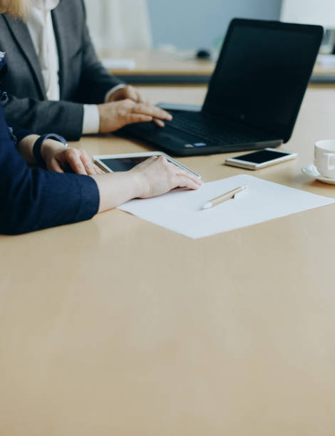 istock business talks two people office with laptop 1056028486
