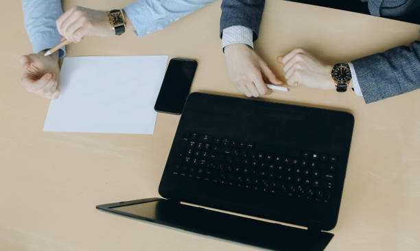 istock business talks two people office with laptop 1056028502