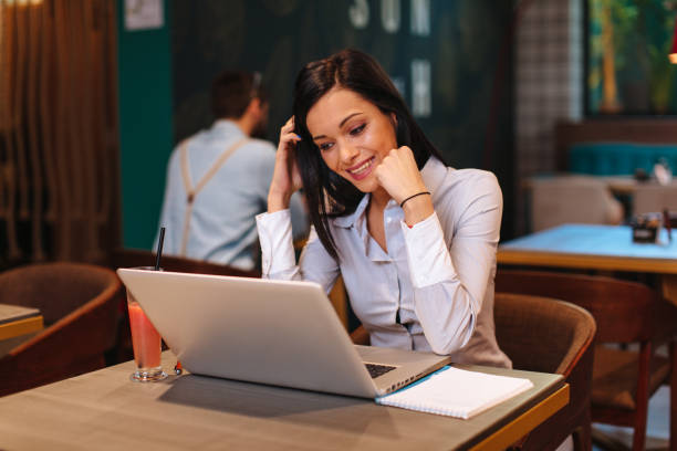 istock Young happy business woman using a laptop in a cafe 1056029076