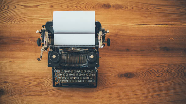 istock Retro typewriter on wooden desk 1056031752