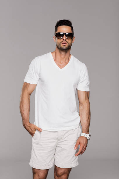 istock Handsome man in white summer clothes wear sunglasses 1056032820