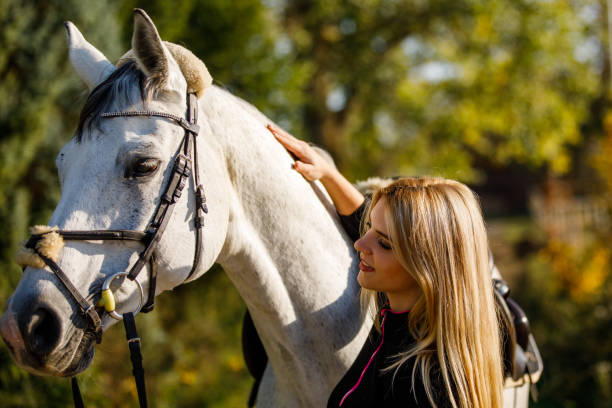istock Woman with horse in park 1056039556