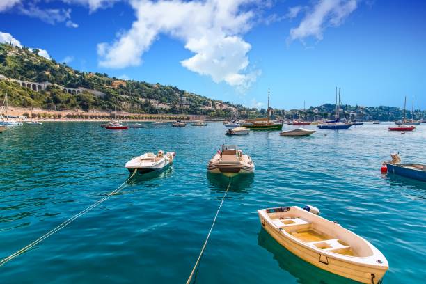 istock Small Boats Moored in Calm Blue Bay 1056041584