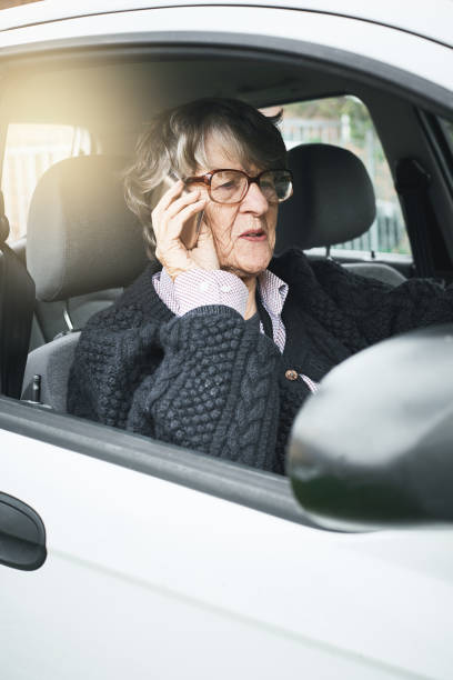 istock Senior woman car driver talking on smart phone 1056044882