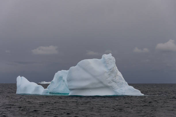istock Antarctic seascape with iceberg 1056050112