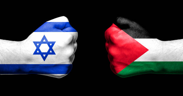 Flags of Israel and Palestine painted on two clenched fists facing each other on black background/Israel - Palestinian conflict concept stock photo