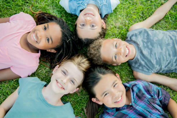 istock Kids lying on the grass and smiling as seen from above 1056054822