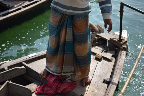 istock boat master on a river in Bangladesh 1056057554