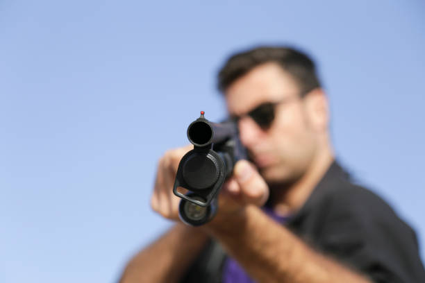 Man shooting on an outdoor shooting range, selective focus