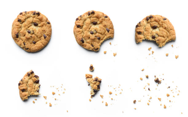 Steps of chocolate chip cookie being devoured. Isolated on white background. stock photo