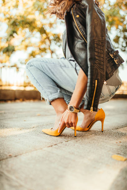 istock Young pretty fashioned girl. New Shoes Problems 1056061792