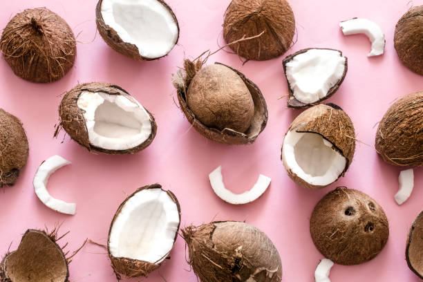 istock Coconut halves on pink background 1056063810