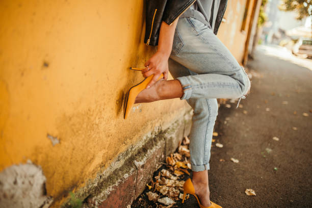 istock Young pretty fashioned girl. New Shoes Problems 1056064170