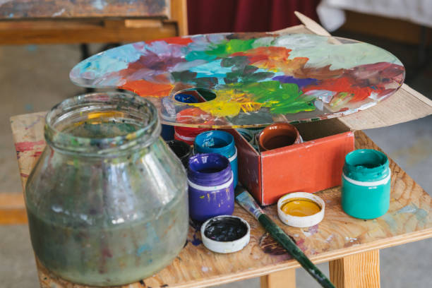 istock Paints, brushes and a palette are on the table close-up 1056072142