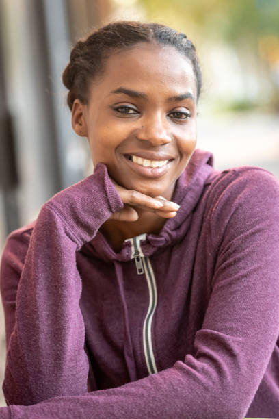 istock Smiling beautiful young black woman 1056080250