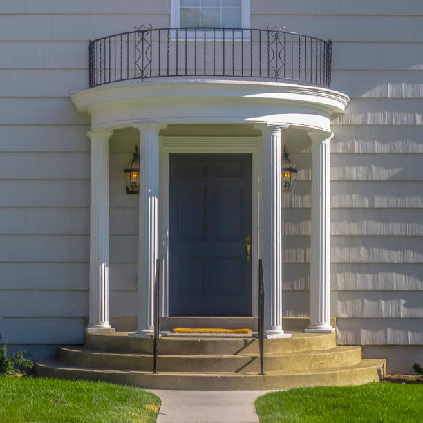 istock Home with gray door columns balcony and stairs 1056087096