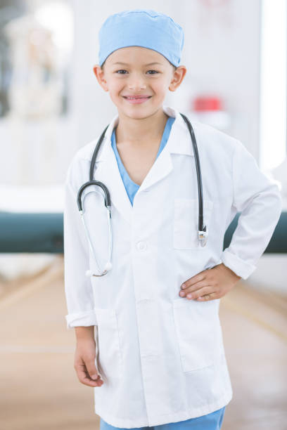 istock Ethnic boy dressed like a doctor in scrubs 1056092970
