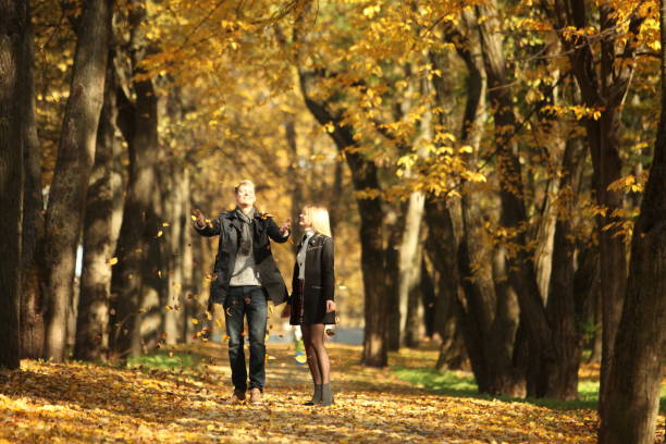 istock happy couple in autumn park 1056093286