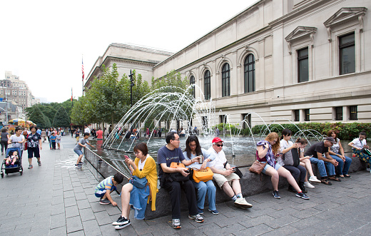 New York, NY: A crowd—including many Asians—walking and relaxing near a fountain outside the Metropolitan Museum of Art on Manhattan’s Upper East Side.