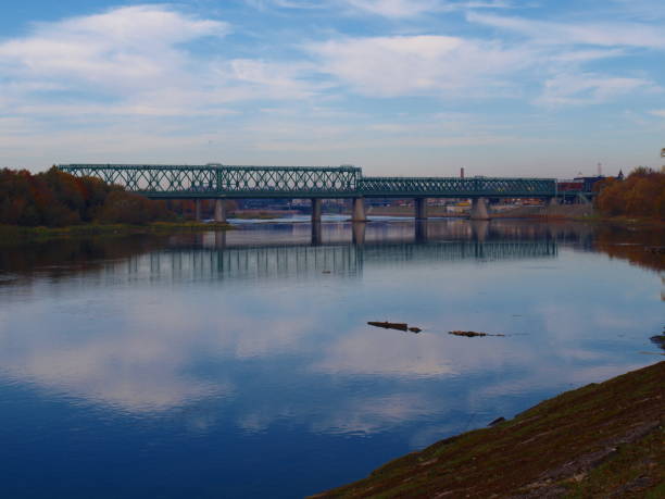 istock Old green railway bridge across the river 1056104864