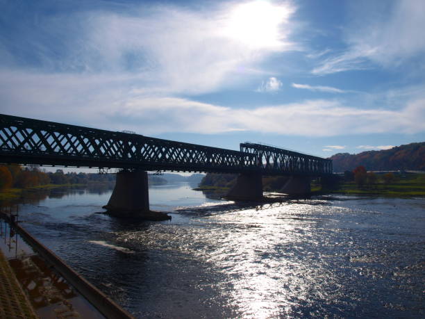 istock Old green railway bridge across the river 1056104868
