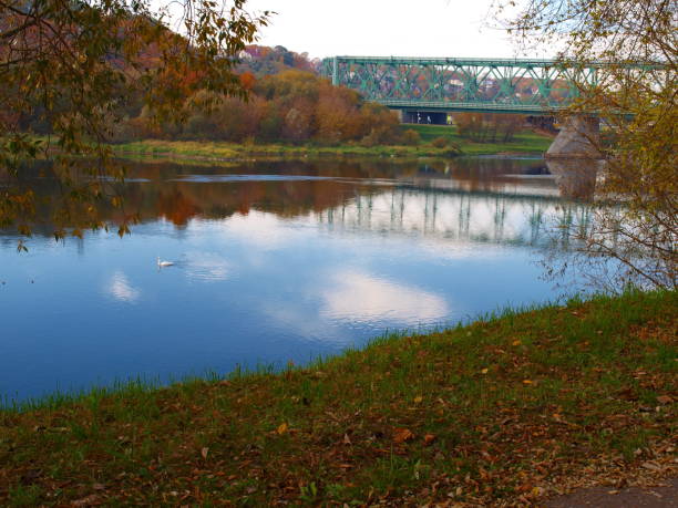 istock Old green railway bridge across the river 1056104870