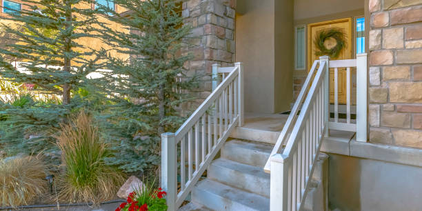 istock Stairs leading to a yellow front door with wreath 1056105242