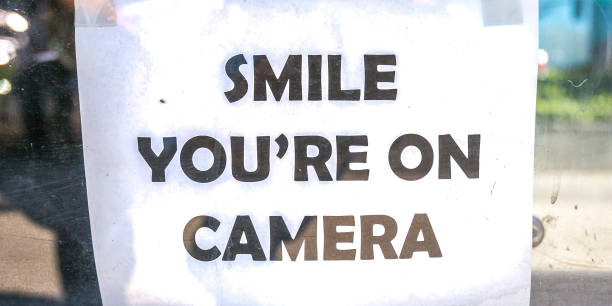 istock Smile youre on camera sign on a glass window 1056105306