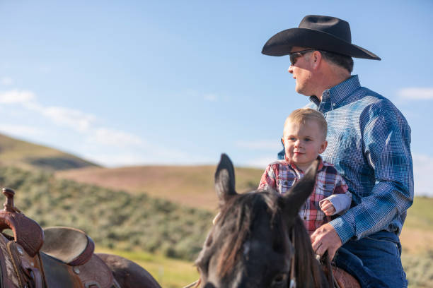 istock Cowboy Playing With his Baby Son on Horseback 1056108920