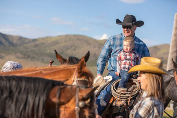 istock Cowboy Playing With his Baby Son on Horseback 1056108928