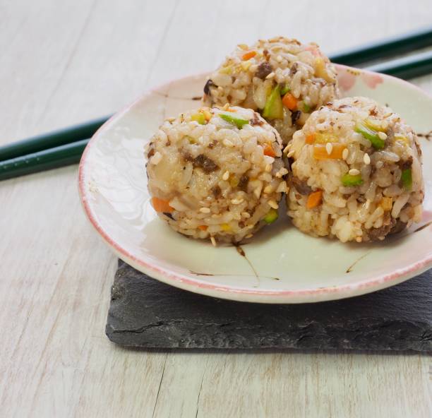 Asian food  beef and vegetables rice balls and pickled radish