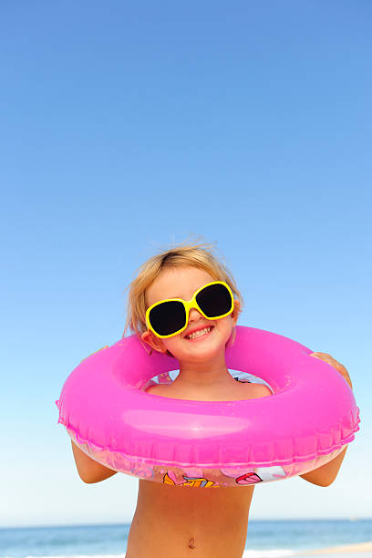 istock child with sunglasses and inflatable ring at the beach 105611596